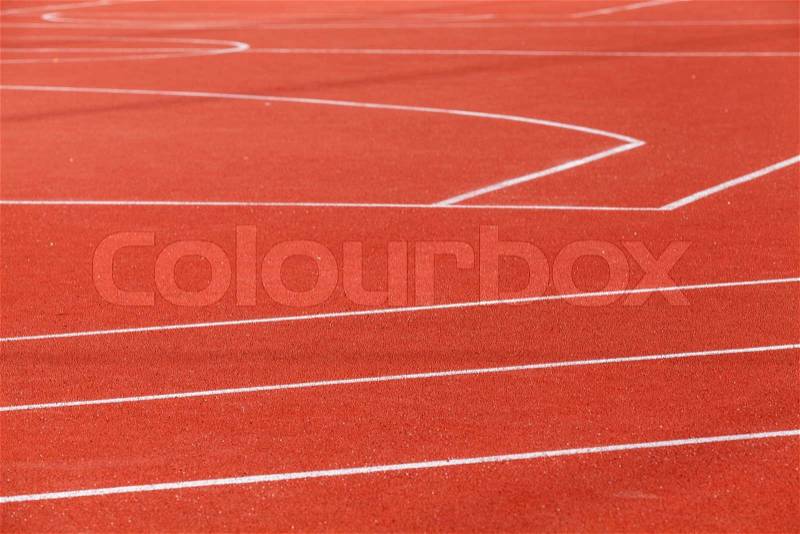 Red sports ground with white marking lines, stock photo