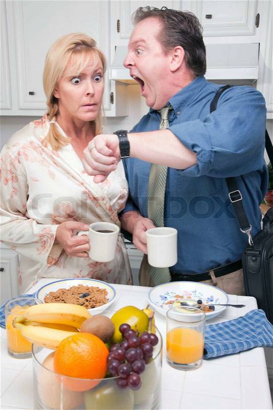 Late for Work Stressed Couple Checking Time in Kitchen, stock photo
