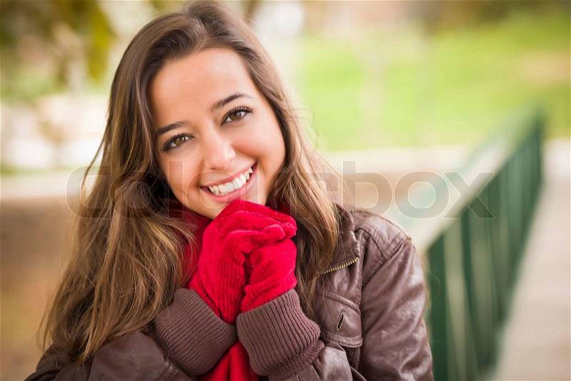 Pretty Festive Smiling Woman Portrait Wearing a Red Scarf and Mittens Outside, stock photo