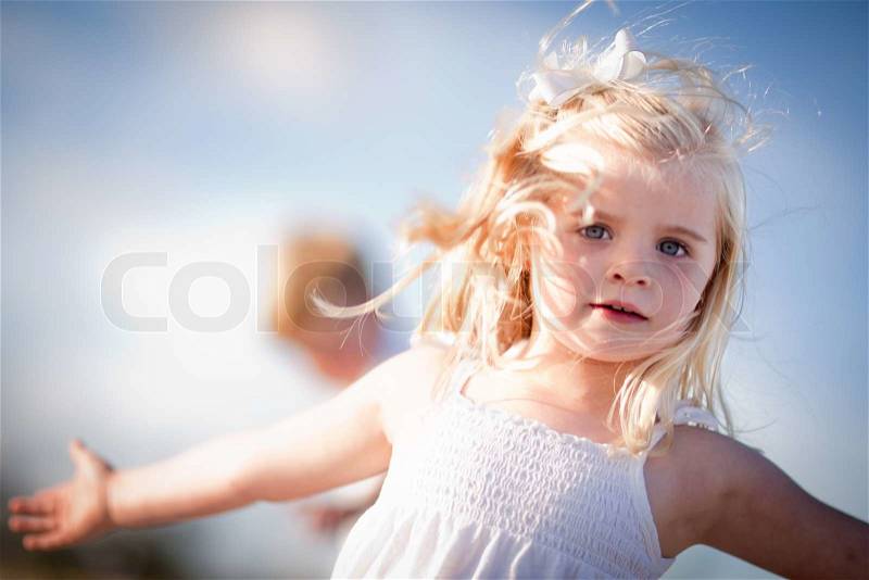 Adorable Blue Eyed Girl Playing Outside with Her Family, stock photo