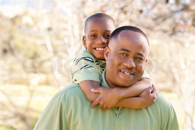 African American Man and Child Having Fun in the Park, stock photo