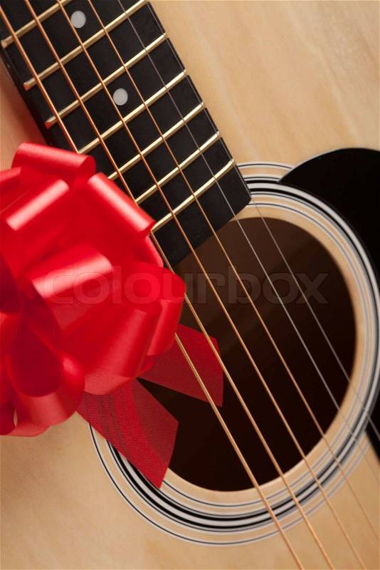 Guitar Strings with Red Ribbon - The Gift of Music, stock photo