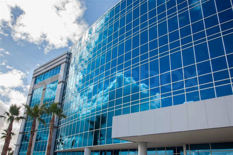 Dramatic Reflective Corporate Building with Blue Sky and Clouds, stock photo