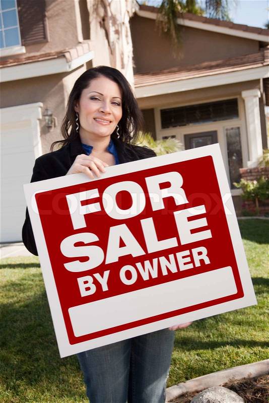 Happy Attractive Hispanic Woman Holding For Sale By Owner Real Estate Sign In Front of House, stock photo