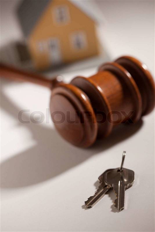 Gavel, House Keys and Model Home on Gradated Background with Selective Focus, stock photo