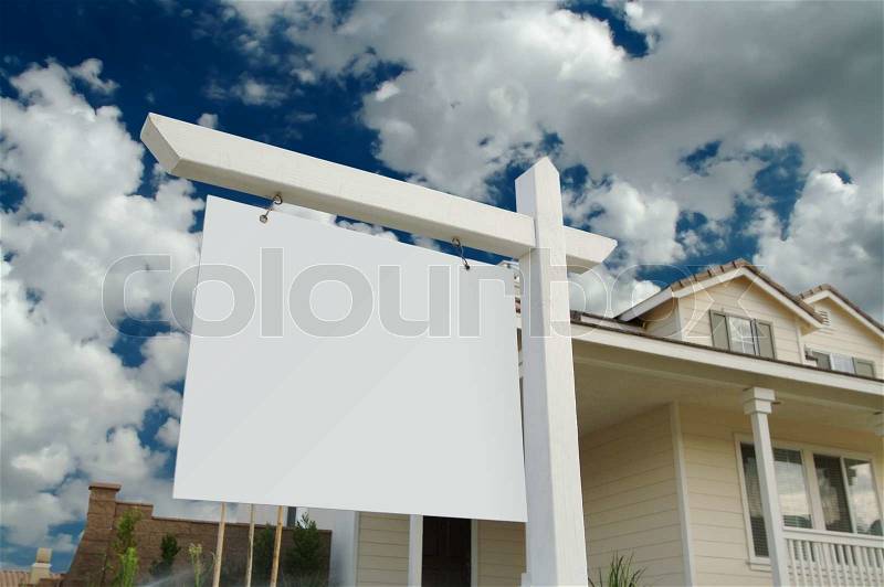 Blank Real Estate Sign in Front of Beautiful New Home, stock photo