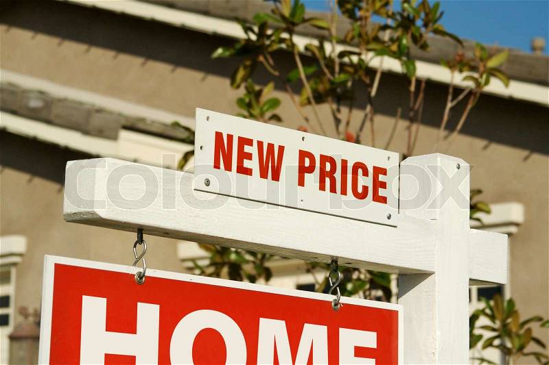 New Price Real Estate Sign in Front of Beautiful New Home, stock photo