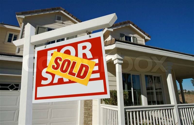 Sold Home For Sale Sign in Front of Beautiful New House, stock photo