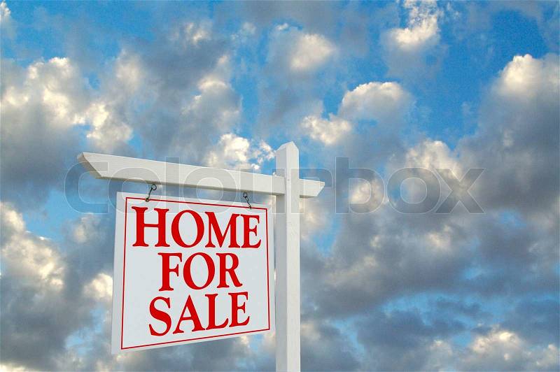 Home For Sale sign on dramatic cloudy background, stock photo