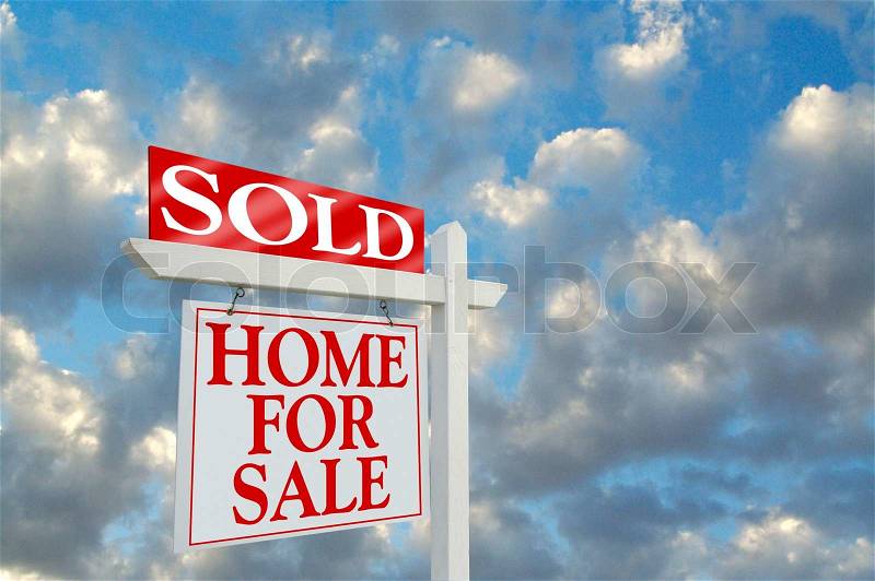 Sold Home for Sale sign on dramatic clouds background with room for your message, stock photo