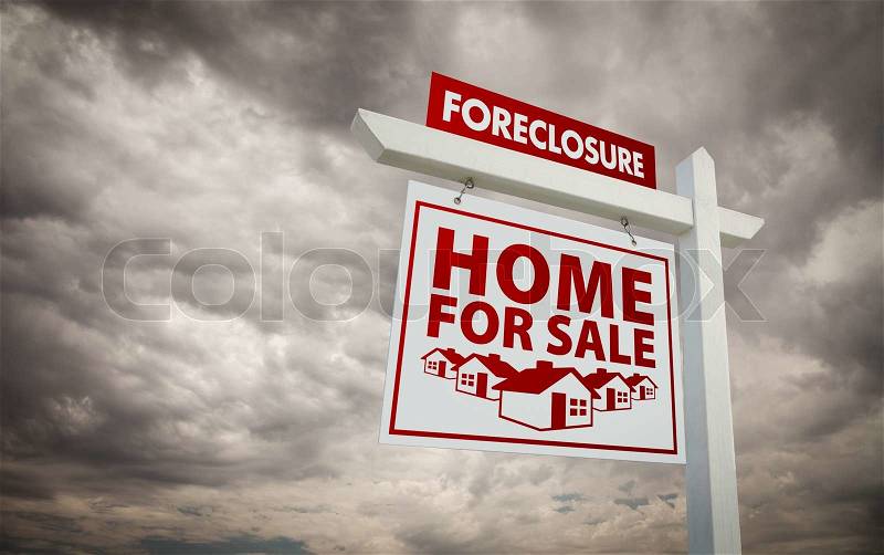White and Red Foreclosure Home For Sale Real Estate Sign Over Ominous Cloudy Sky, stock photo