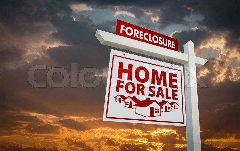 White and Red Foreclosure Home For Sale Real Estate Sign Over Beautiful Clouds and Sunset Sky, stock photo