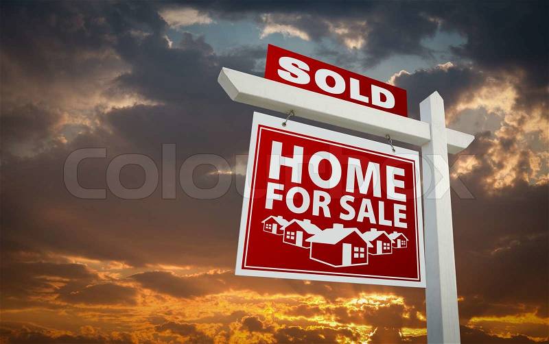 Red Sold Home For Sale Real Estate Sign Over Beautiful Clouds and Sunset Sky, stock photo