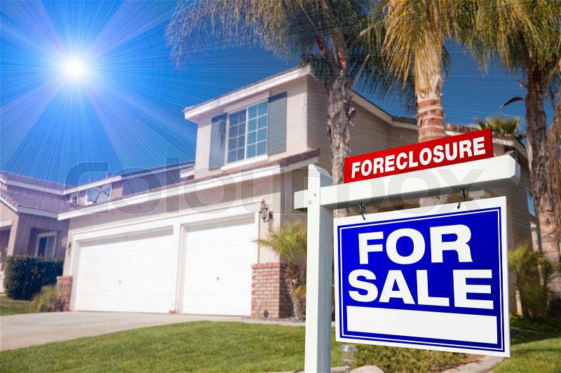 Blue Foreclosure For Sale Real Estate Sign in Front of House with Blue Star-burst in Sky, stock photo