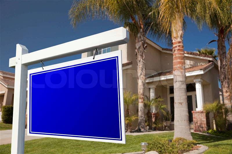 Blank Real Estate Sign in Front of House, stock photo