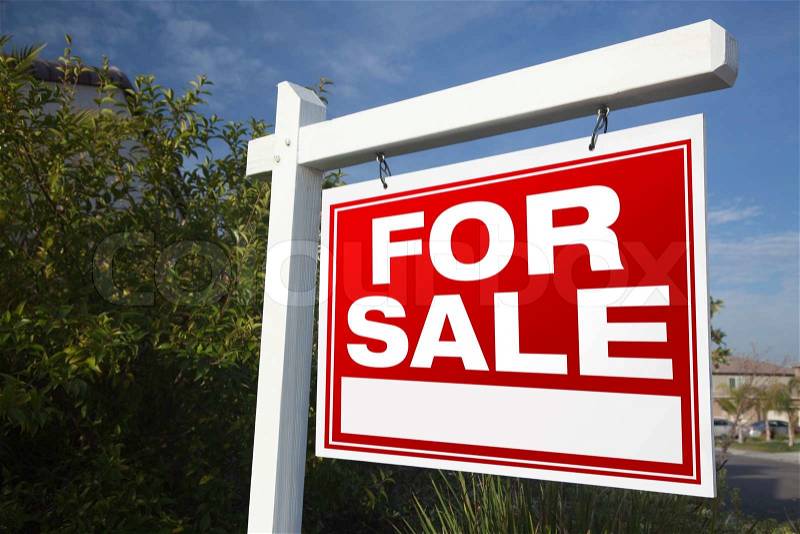 For Sale Real Estate Sign In A Neighborhood, stock photo