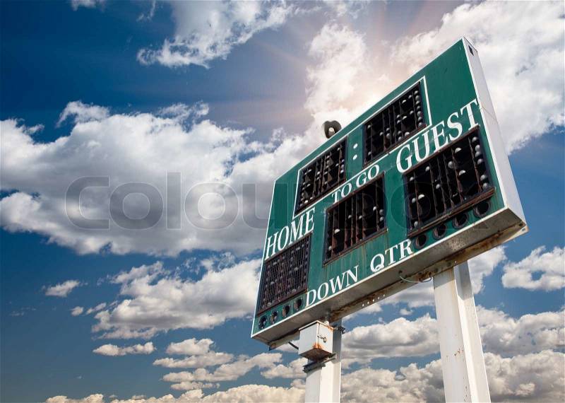 HIgh School Score Board on a Dramatic Blue Sky with Clouds and Sun Rays, stock photo