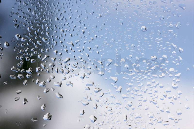 Rain Drops on Window as the clouds clear behind, stock photo
