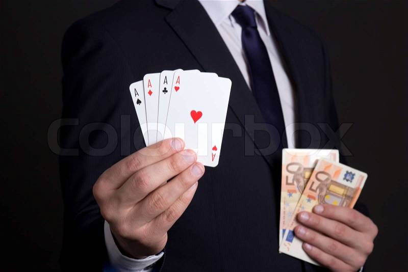 Four aces cards and euro banknotes in mans hands, stock photo
