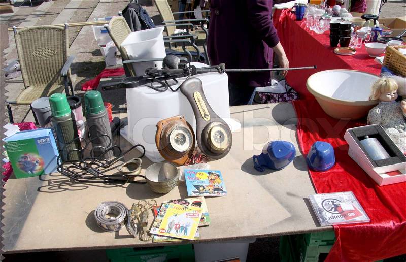 Scene from Flea market where people sell and buy used toys, clothes, pictures, kitchen ware and other things, stock photo