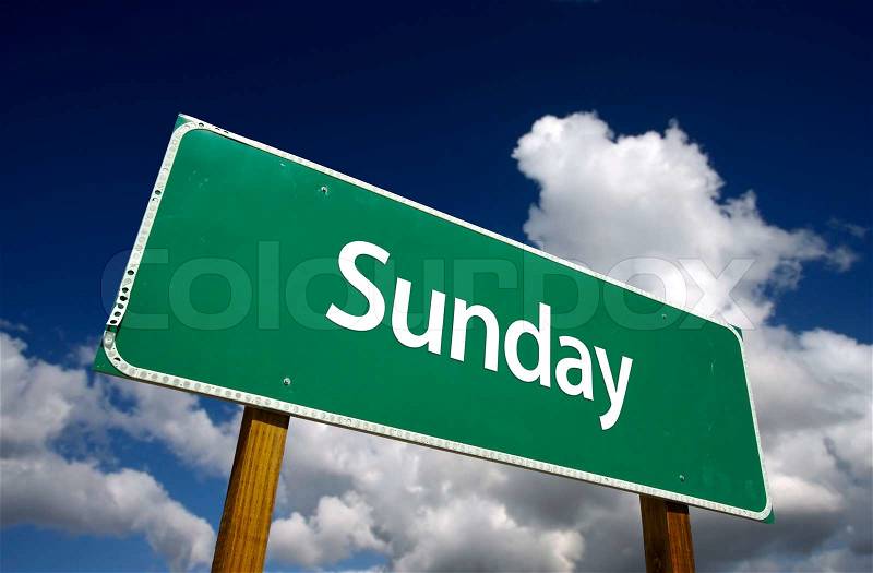 Sunday Green Road Sign with dramatic blue sky and clouds - Days of the Week Series, stock photo