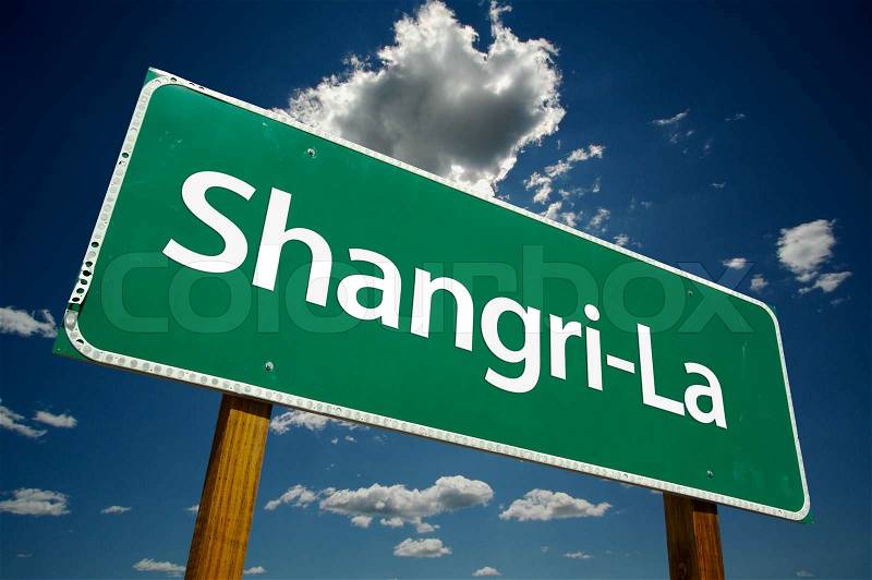 Shangri-La Green Road Sign with Dramatic Clouds and Sky, stock photo