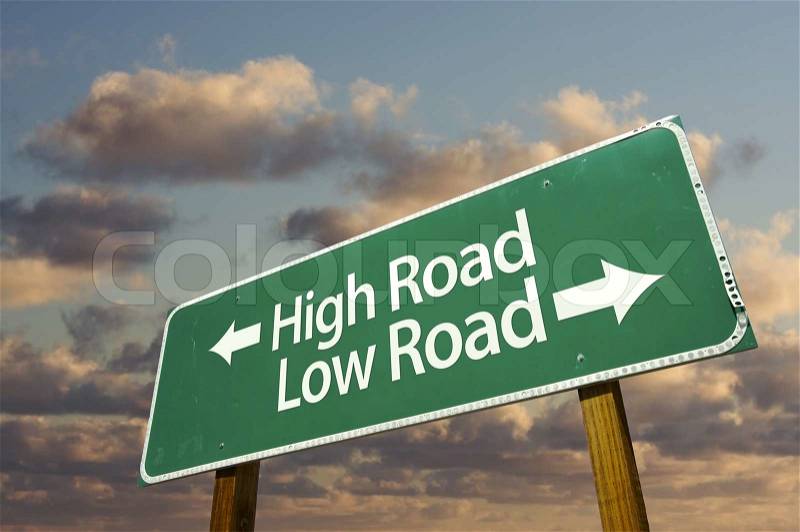 High and Low Road Green Road Sign with dramatic blue sky and clouds, stock photo