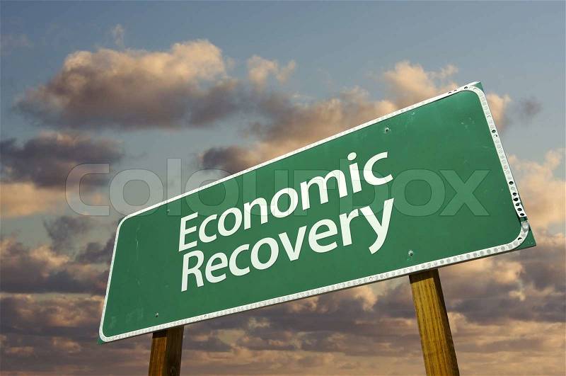 Economic Recovery Green Road Sign with dramatic clouds and sky, stock photo