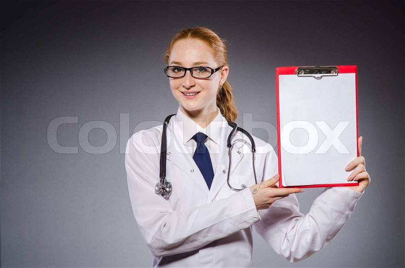 Woman doctor with paper notepad , stock photo