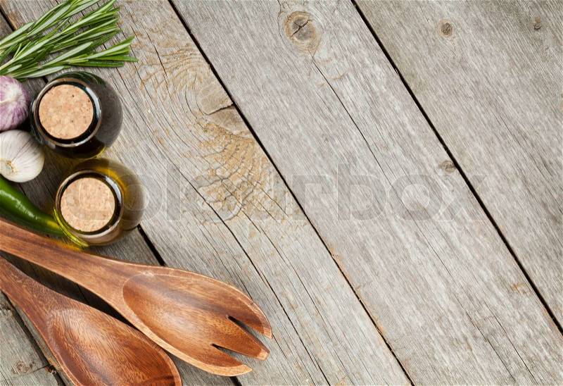 Herbs, spices and seasoning with utensils over wooden table background with copy space, stock photo