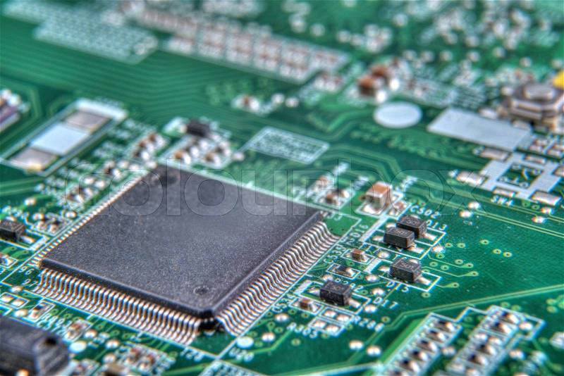 A green circuit board, solderings and paths, stock photo