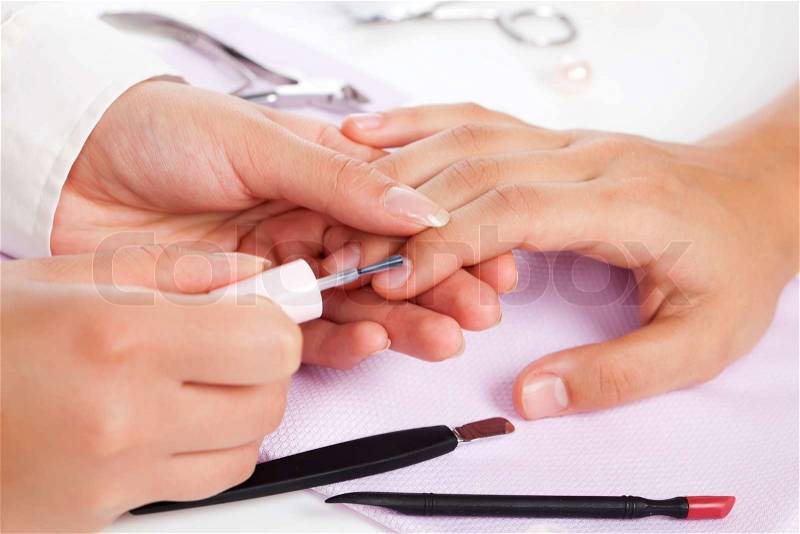 Manicure. Care of fingers of hands, cleaning, covering a varnish of nails, stock photo