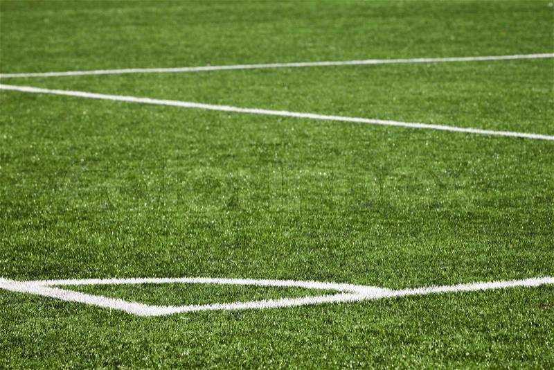 Football playing field background with white marking on green grass, stock photo
