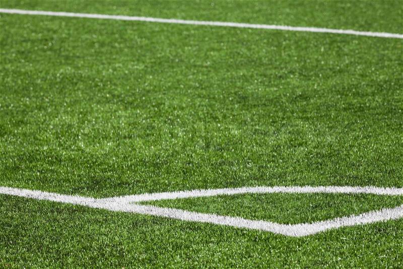 Football playing field background with green grass and white corner marking, stock photo