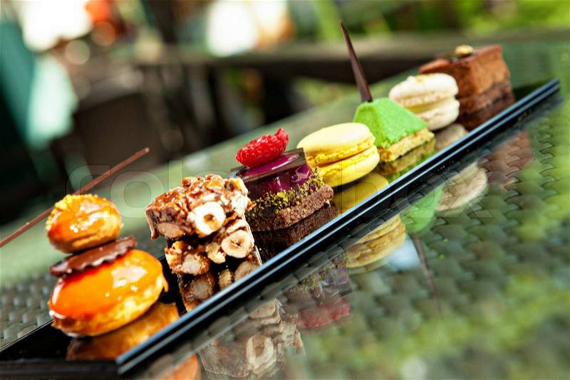 Gorgeous view of different cakes and biscuits, served in outdoors, stock photo