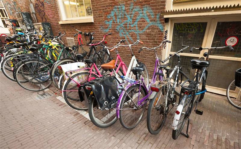 AMSTERDAM, NETHERLANDS - MARCH 19, 2014: Different bicycles stand on a parking place in Amsterdam, stock photo