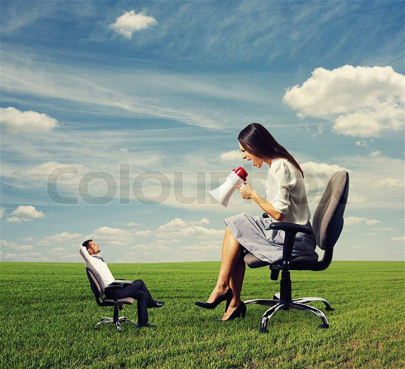 Smiley small man and angry big woman on the field, stock photo