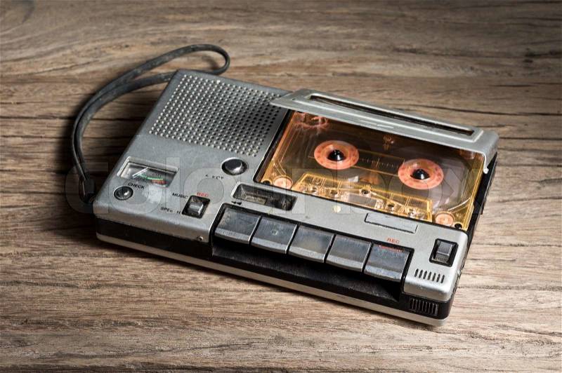 Old Cassette Tape player and recorder with audio cassette on old wood background, stock photo