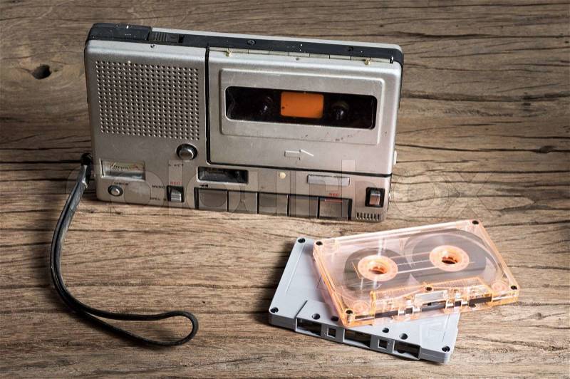 Old Cassette Tape player and recorder with audio cassette on old wood background, stock photo