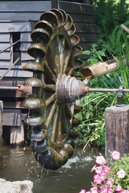 Water wheel turbine. The use falling water to create power .Thailand, stock photo