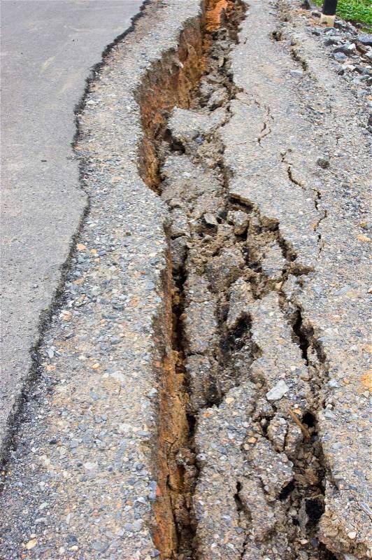 Collapsed and cracked asphalt road after flood, stock photo