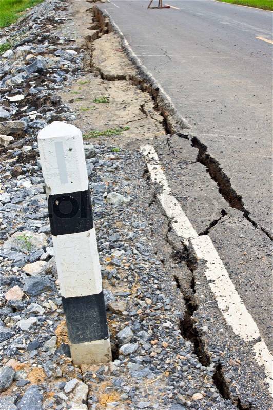 Collapsed and cracked asphalt road after flood, stock photo