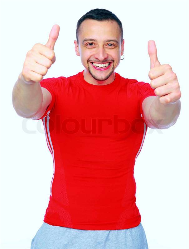 Sportive man thumbing up in red T-shirt over white background, stock photo