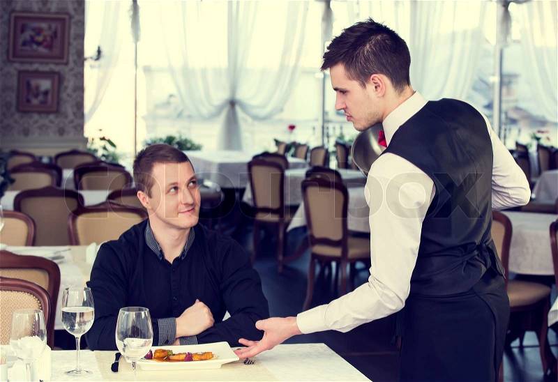Server and client in the restaurant, stock photo