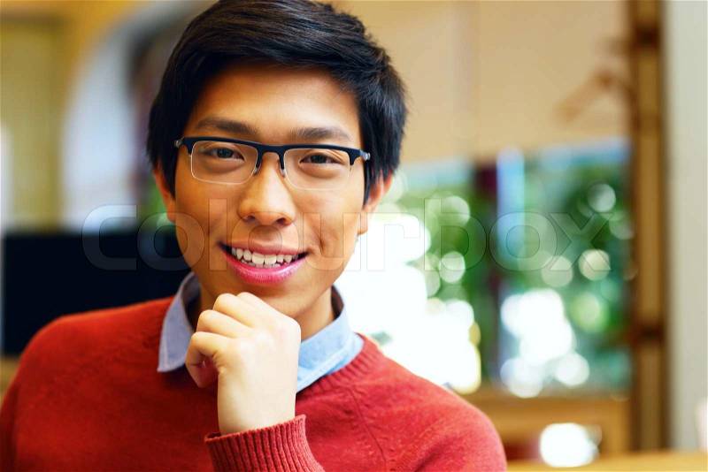 Closeup portrait of a Young happy asian man with glasses, stock photo