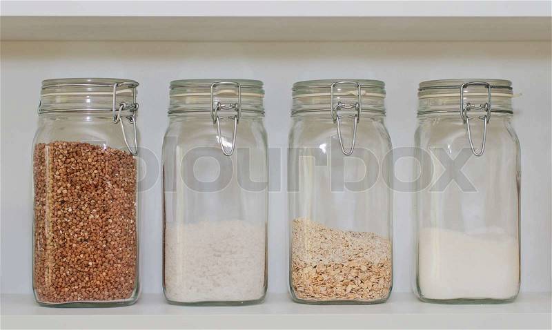 Ingredients in jars on shelf in kitchen, stock photo