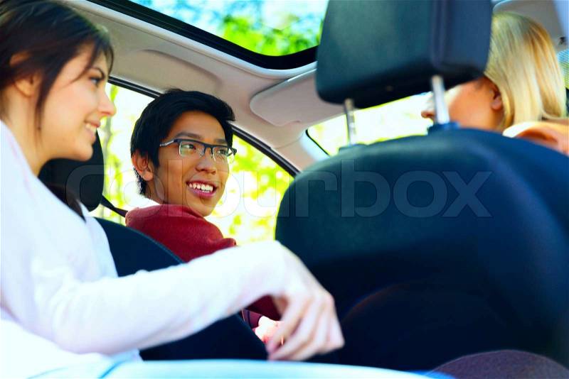Happy friends in the car ready for vacation, stock photo