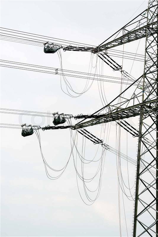 High voltage power pole construction works - cables being mounted, stock photo