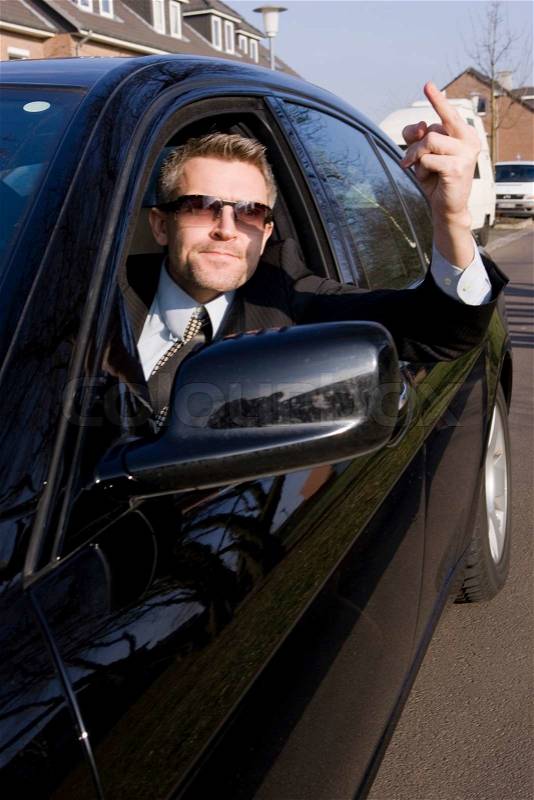 An angry male driver caught in traffic, stock photo